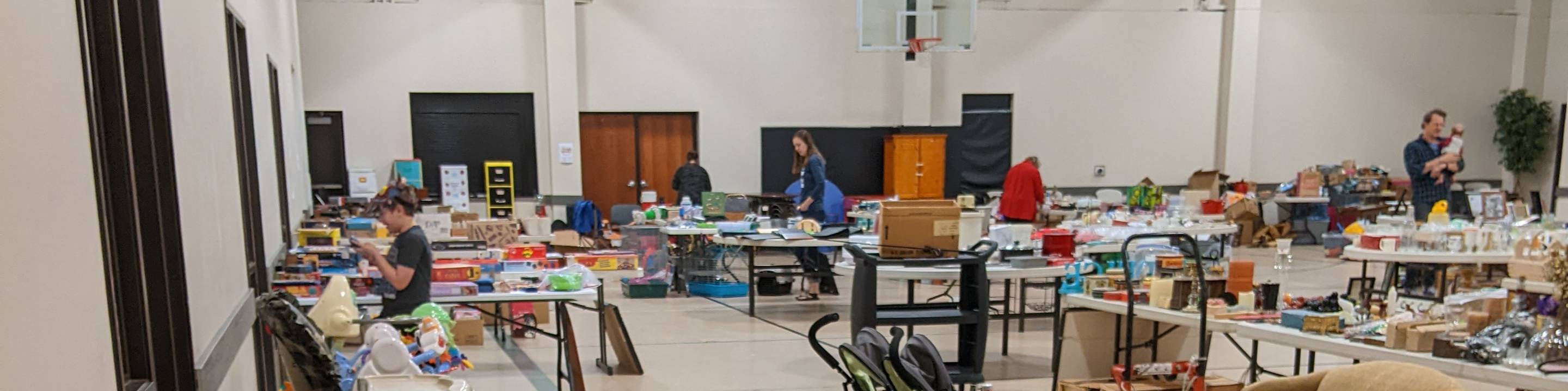 Interior gym view of the community center that is being used as a community garage sale.